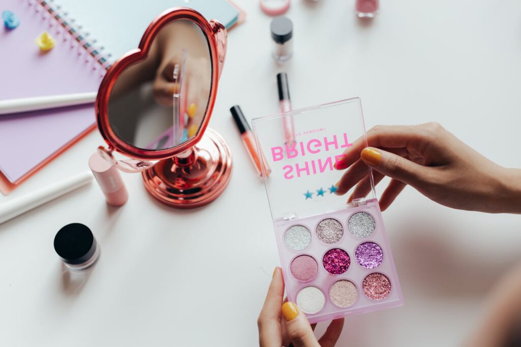 How Successful Entrepreneurs Maximize Productivity A vibrant eyeshadow palette with glittery colors held near a heart-shaped mirror.
