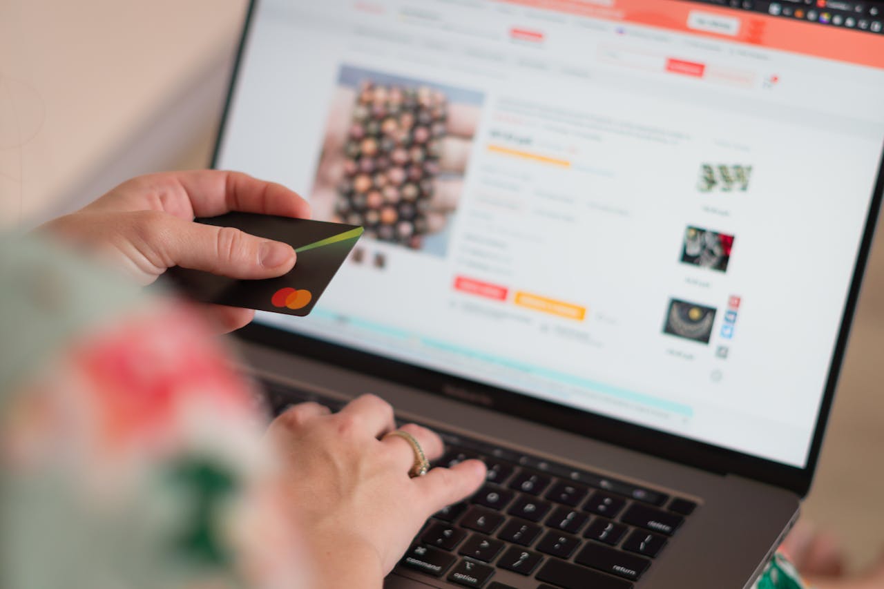 our-journey-02 Engaging in online shopping using a credit card with a laptop for convenience and ease.