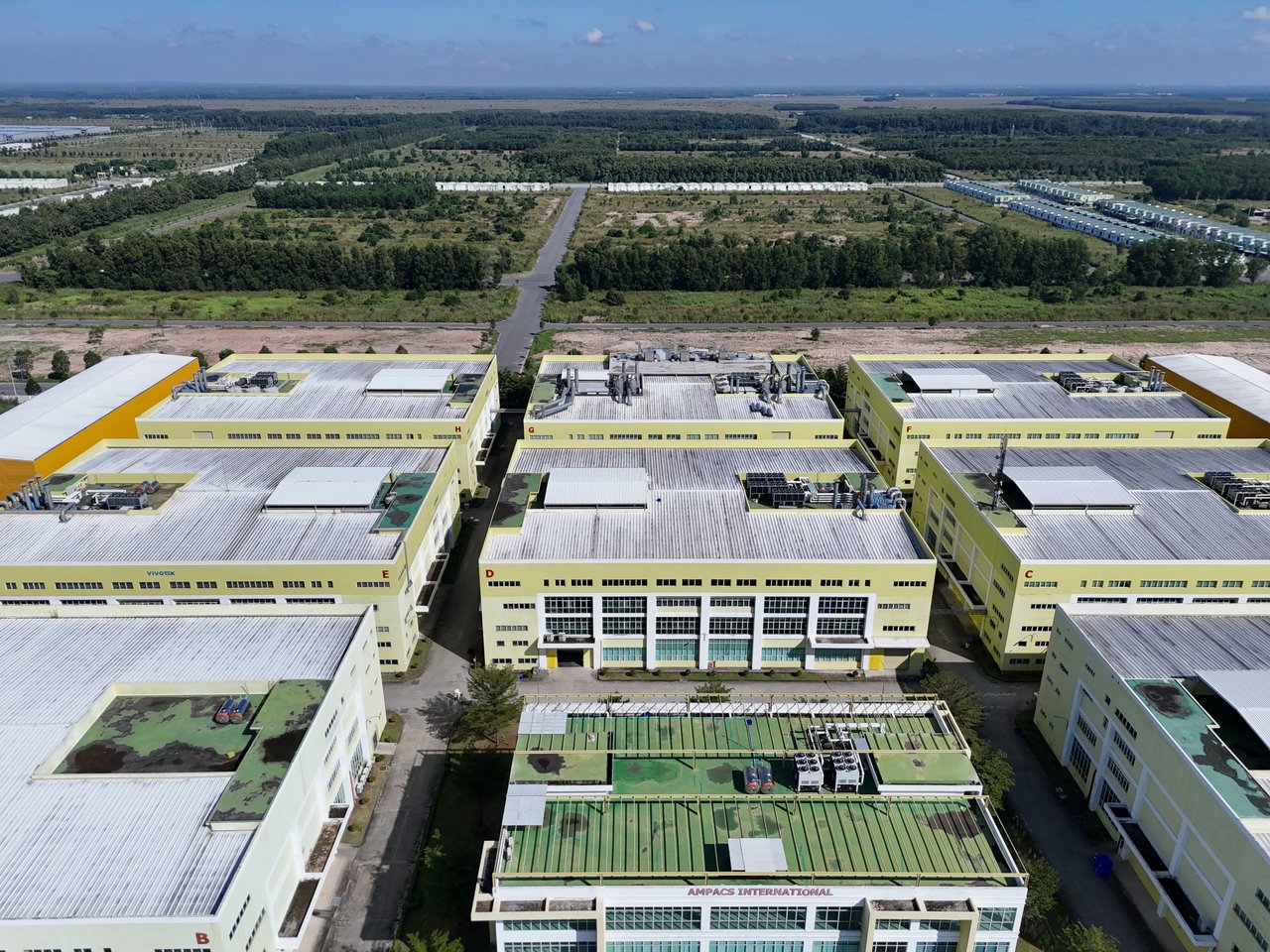 who-we-are-img Aerial shot of a modern industrial complex surrounded by greenery in Bình Dương, Vietnam.