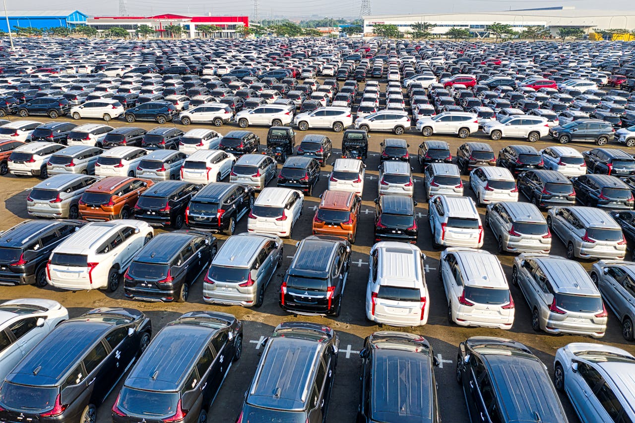 services-03 From above of rows with many modern new shiny automobiles of contemporary industry in daytime